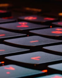 close up of a laptop keyboard with a red light underneath